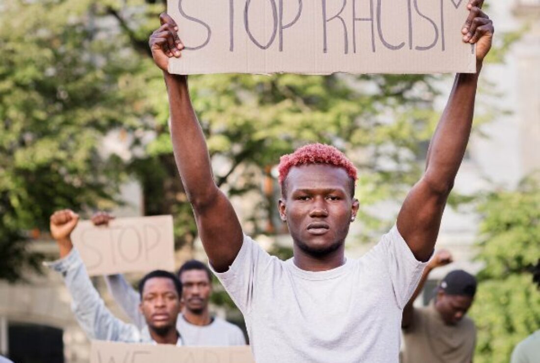Man holding sign saying